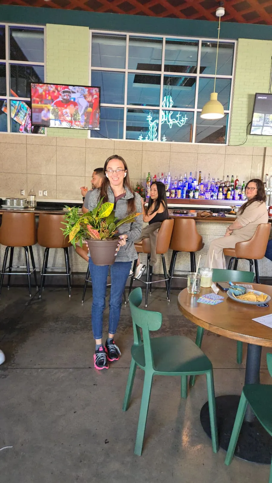 Happy Plant Bingo participants showing their plants at Punch Bowl Social