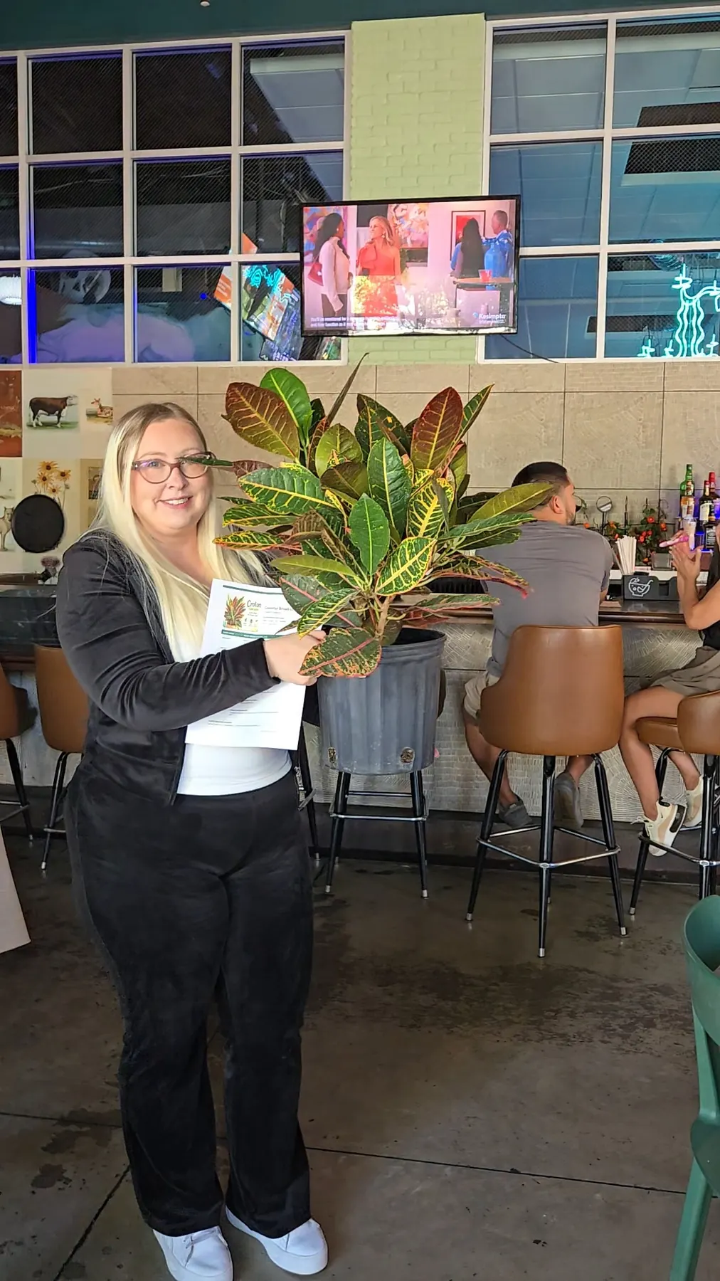 Happy Plant Bingo participants showing their plants at Punch Bowl Social